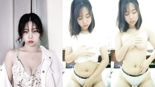 Short-haired beauty with splayed breasts and rabbit teeth masturbates